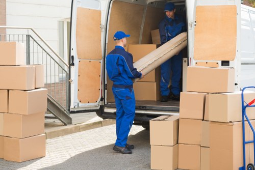 Removal van and moving team in Cranford residential street