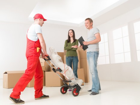 Office removals team preparing desks and boxes for a Cranford business move